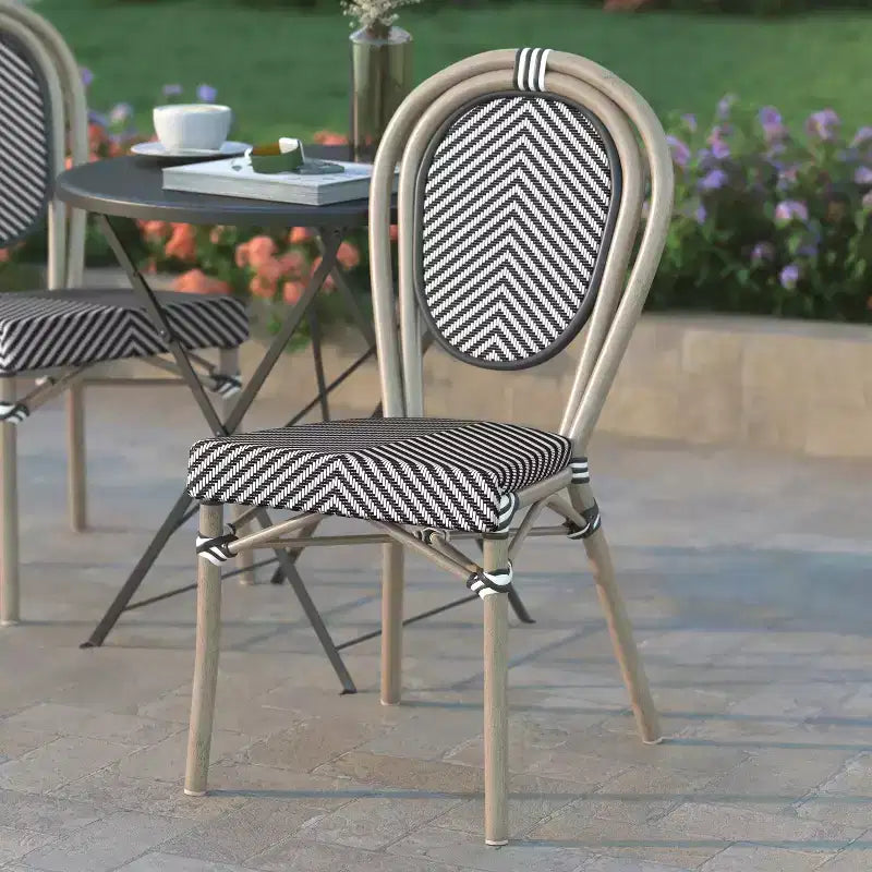 Chaise de bistrot empilable Massalia d'intérieur/extérieur Emma & Oliver, style Thonet, avec assise en textilène et cadre métallique finition bambou